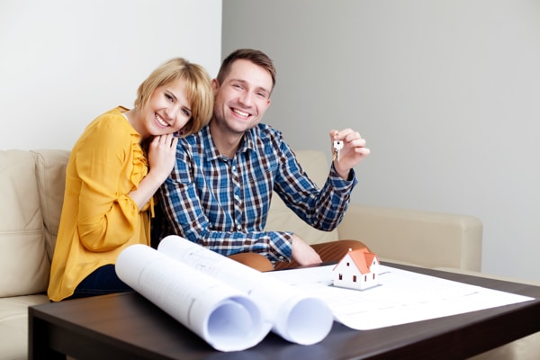 new apartments for sale Off Plan couple looking at plans holding keys