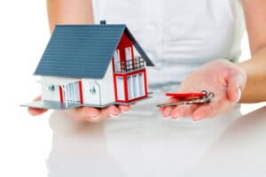 Find a property for sale Assisted Move hands holding model house and keys